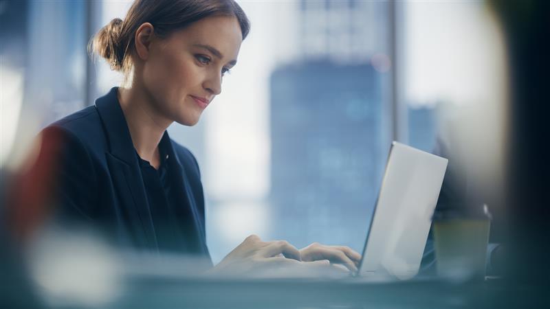 Woman sat at desk working on laptop