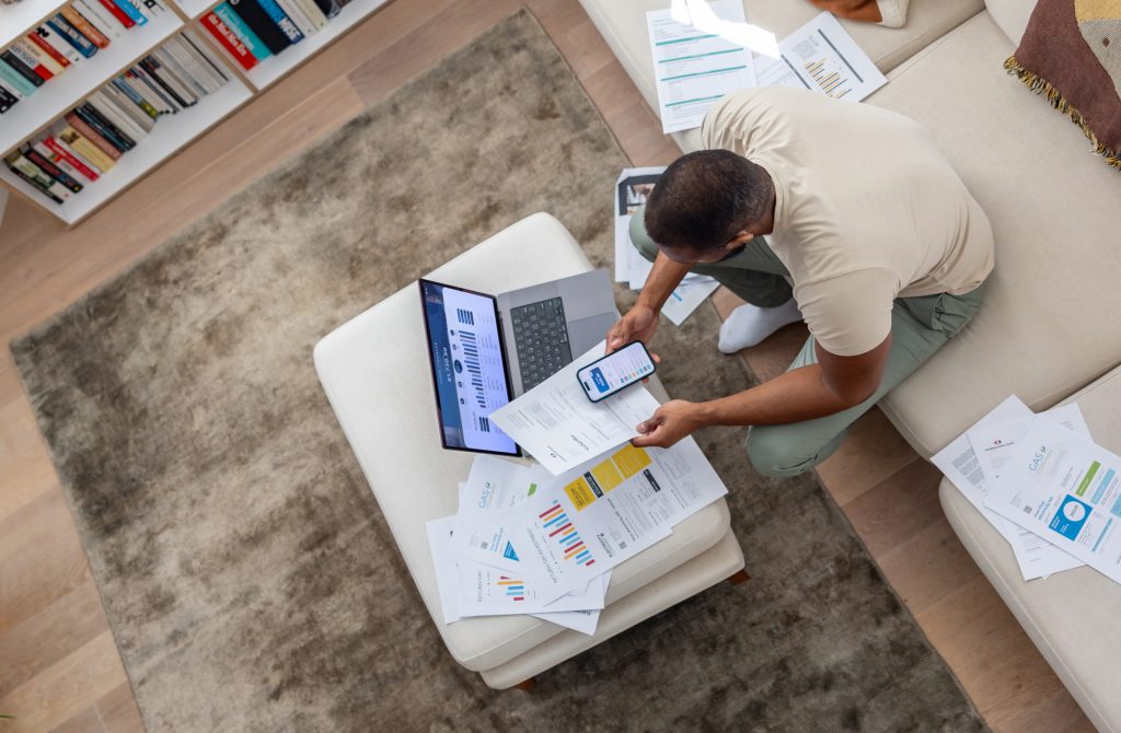 High angle view of a man paying tax online from home and organising his home finances