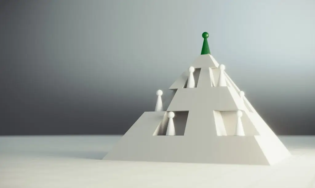 Green pawn of chess, on the top of the pyramid, standing out from the crowd of whites, can be used leadership, hierarchy concepts.